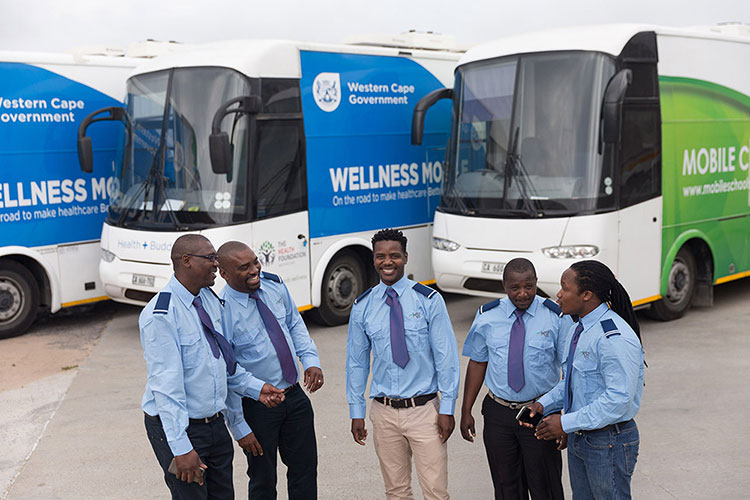 Employee operators standing next to mobile units